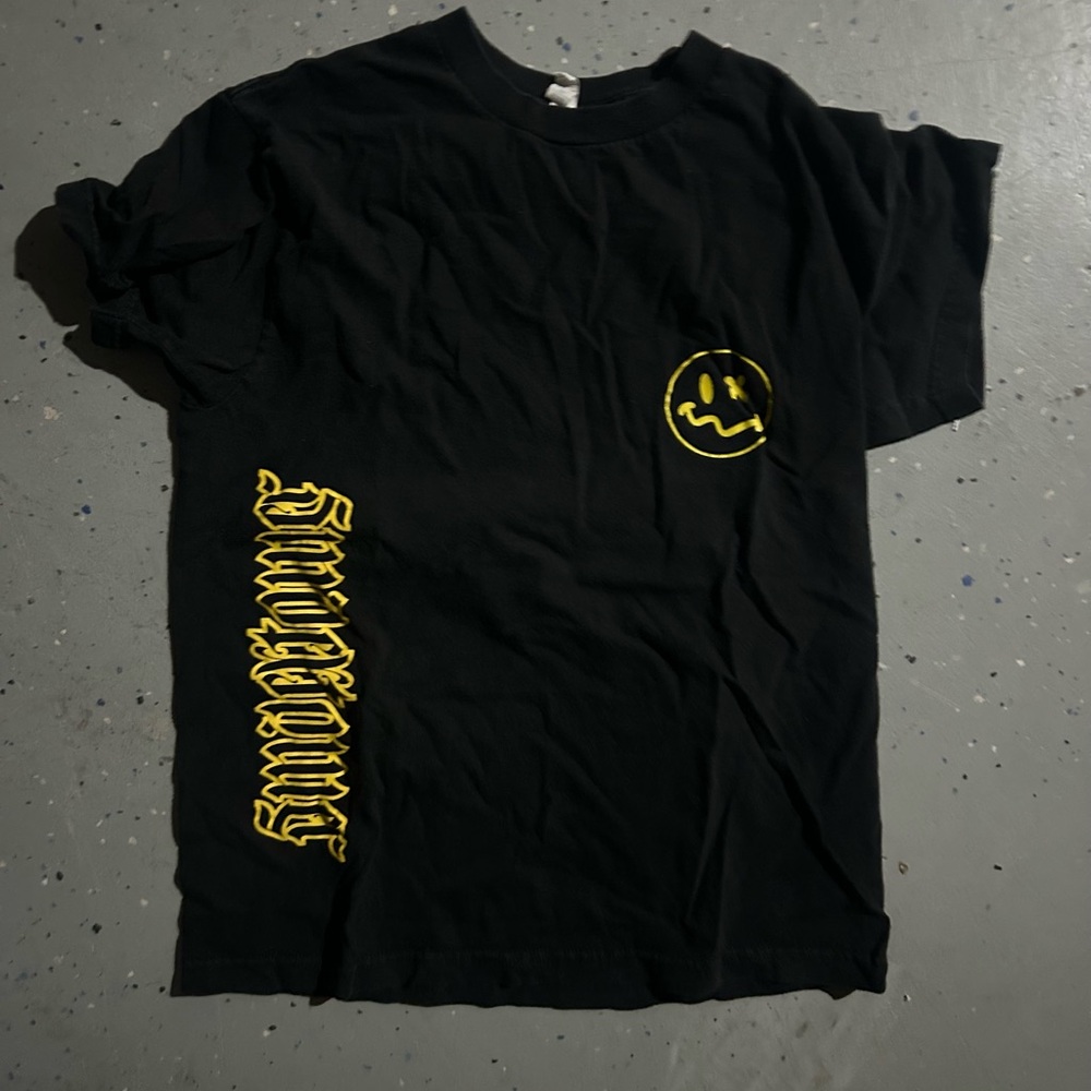 black and yellow smiley tower shirt